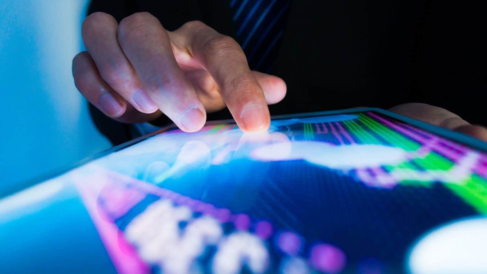 Market analyst using touch screen with data on it