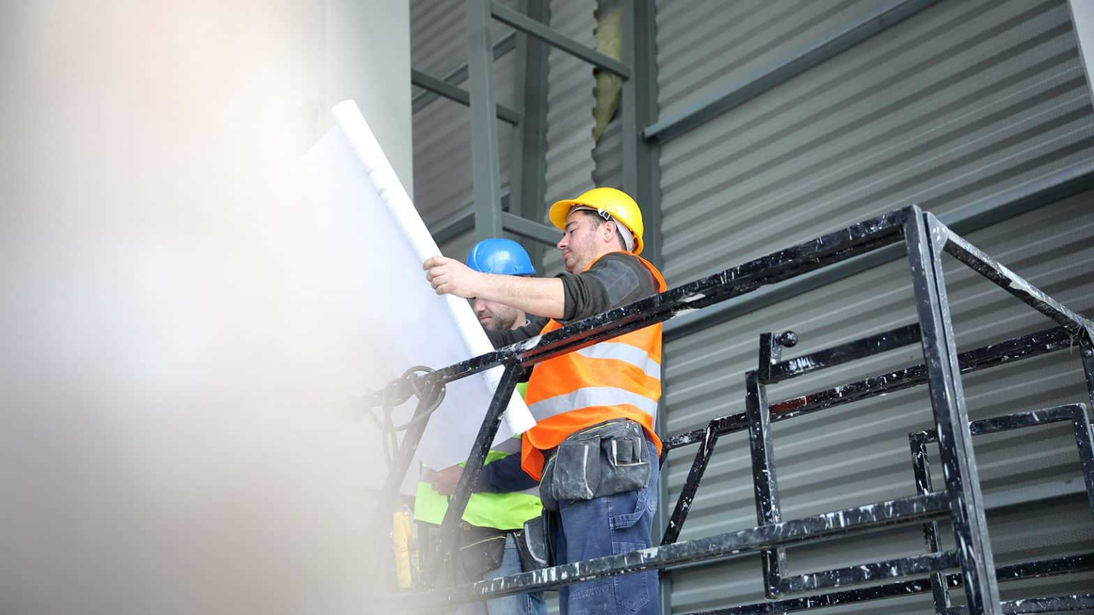 Construction workers reading blueprints