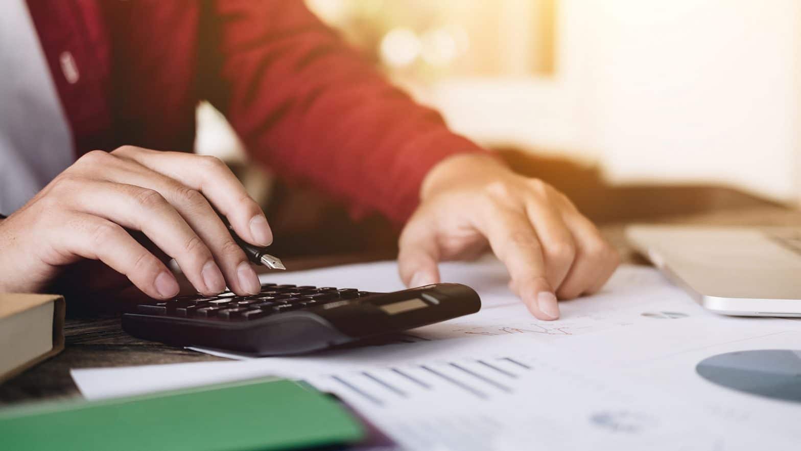 Close up view of bookkeeper or financial inspector hands making report, calculating or checking balance. Home finances, investment, economy, saving money or insurance concept