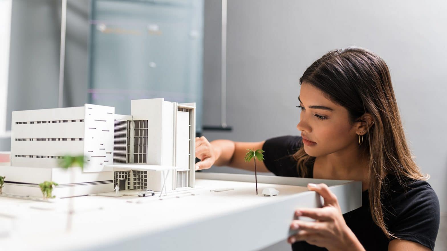 Architect Working Over Model In Office